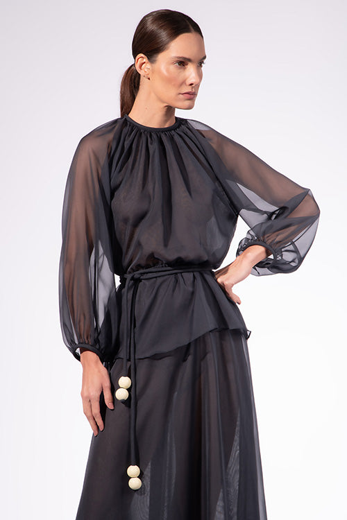 Model wearing the Solid Peplum Maxi Dress detail color navy made with 100% Cotton, styled for resortwear look