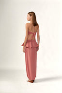 Model wearing the Solid Peplum Maxi Pants back color vintage rose, made with 100% viscose, styled for resortwear look 