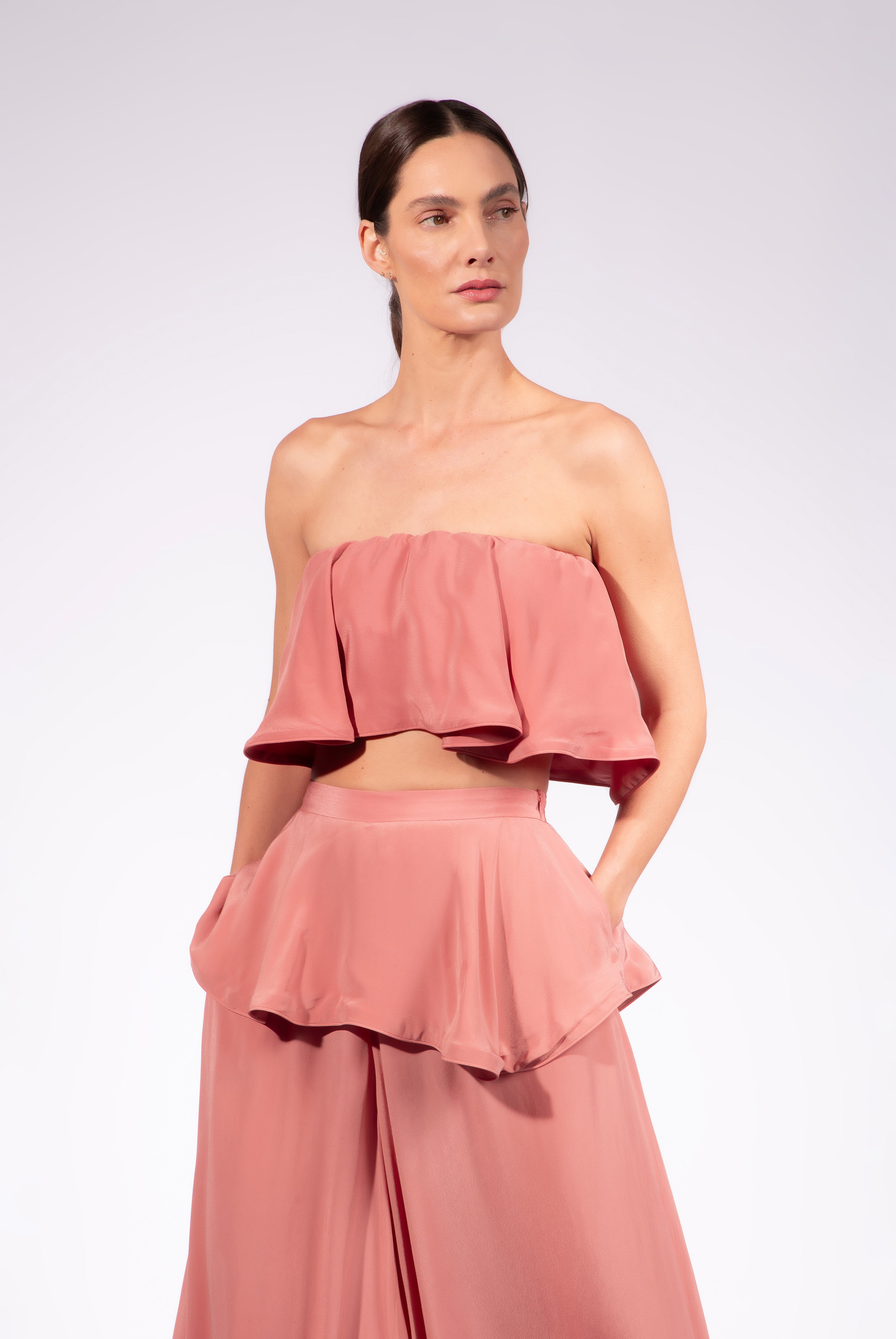 Model wearing the Solid Peplum Maxi Pants detail color vintage rose, made with 100% viscose, styled for resortwear look 