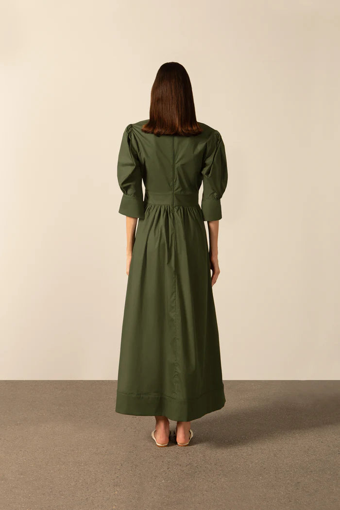 Model wearing the Solid Puff-Sleeved Long Dress back color dark green with 98% cotton and 2% elastane fabric styled for a resort look