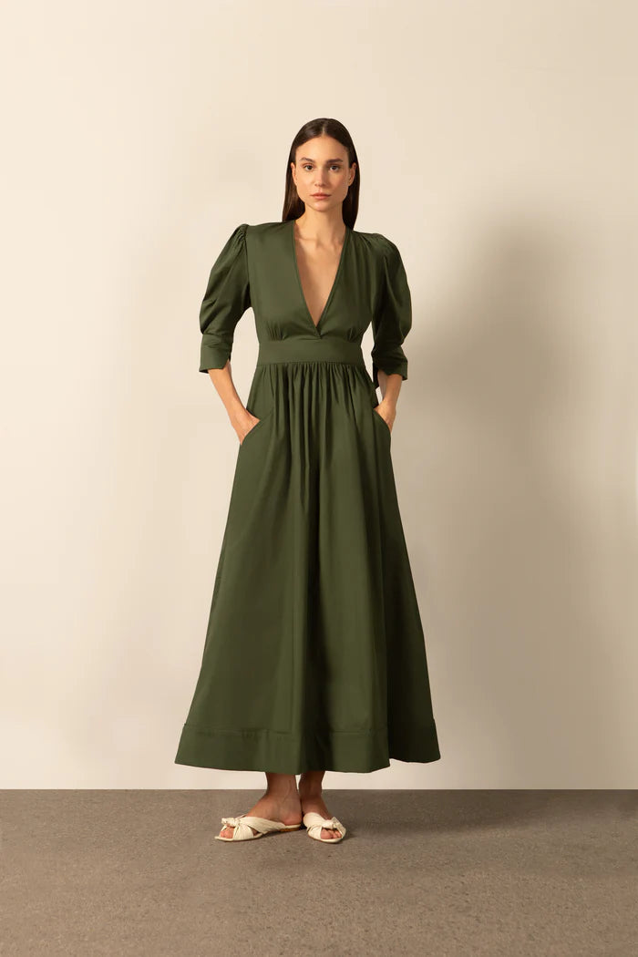 Model wearing the Solid Puff-Sleeved Long Dress color dark green with 98% cotton and 2% elastane fabric styled for a resort look