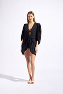 Model wearing the Solid Puff-Sleeved Shirt color black with 100% viscose fabric styled for a resort look