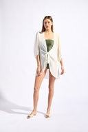 Model wearing the Solid Puff-Sleeved Shirt color off white with 100% viscose fabric styled for a resort look