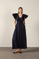 Model wearing the Solid Ruffled Maxi Dress front color navy made with 55% viscose 45% Linen, styled for resortwear look