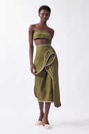 Model wearing the Solid Ruffled Midi Skirt front, color green, made from 98% cotton 2% elastane, styled for a resort look