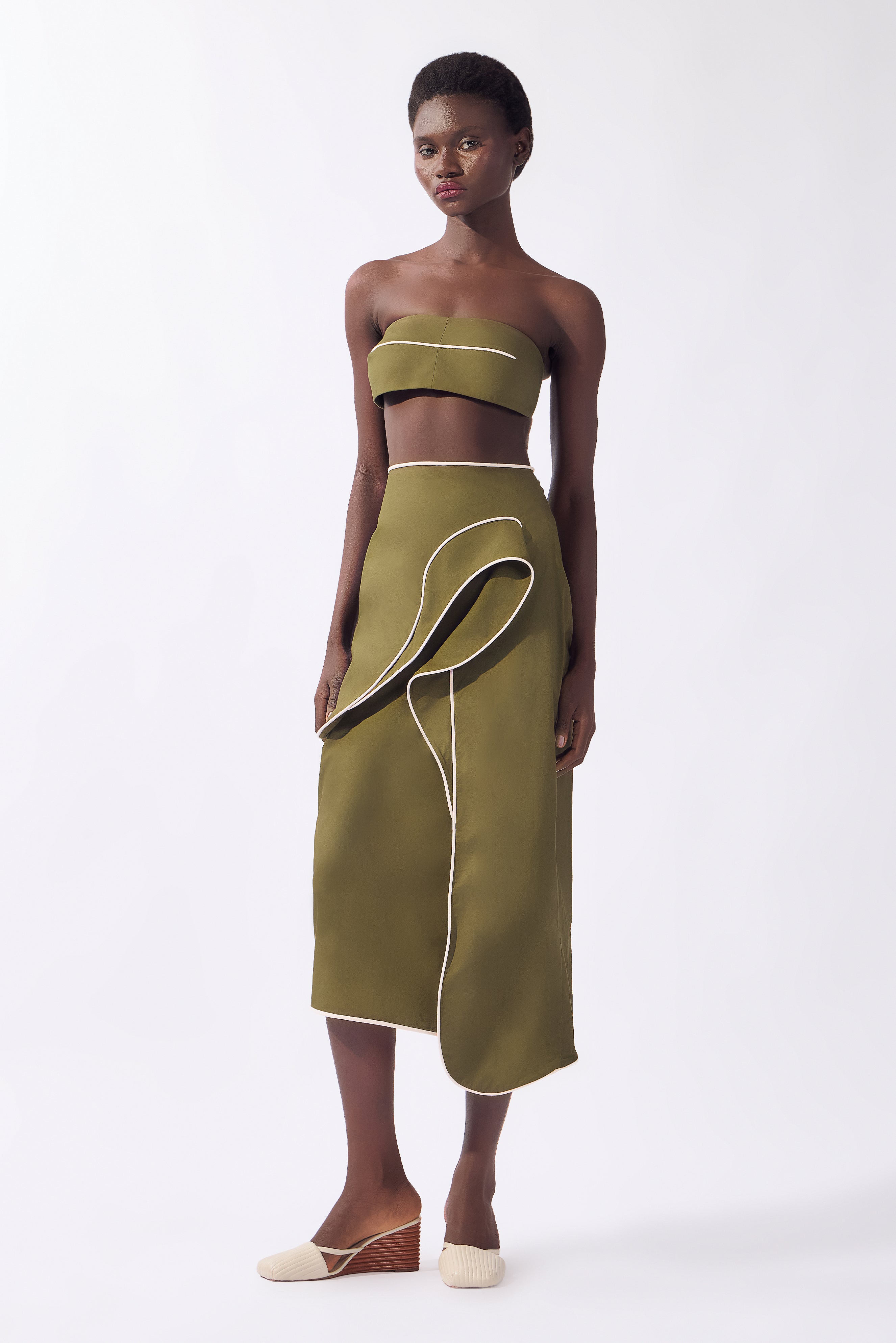 Model wearing the Solid Ruffled Midi Skirt look, color green, made from 98% cotton 2% elastane, styled for a resort look