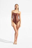 Model wearing the Solid Straps Swimsuit cappuccino, made from 85% polyamide 15% elastane, styled for a beachwear look