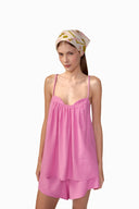 Model wearing the Solid Top and Shorts Set front color pink, made with 90% viscose 10% polyester fabric, styled for resortwear look 