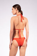 Model wearing the Solid Triangle Bikini back color paprica with 85% Polyamide 15% Elastane, styled for a beachwear look
