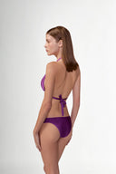 Model wearing the Solid Triangle Bikini back color purple with 85% Polyamide 15% Elastane, styled for a beachwear look