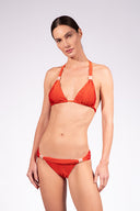 Model wearing the Solid Triangle Bikini color paprica with 85% Polyamide 15% Elastane, styled for a beachwear look