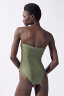 Model wearing the Strapless Swimsuit back color olive, made from 85% polyester 15% elastane, styled for beachwear look