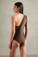Model wearing the Timeless One Shoulder Swimsuit back color coffee with 85% POLYAMIDE 15% SPANDEX fabric for a beachwear look