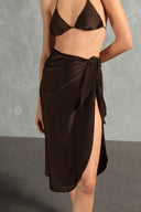 Model wearing the Timeless Pareo Skirt Front back color coffee with 85% POLYAMIDE 15% SPANDEX fabric styled for a resortwear look