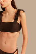 Model wearing the Timeless Straps Bikini Top color coffee made from 85% polyamide 15% elastane, styled for a beachwear look
