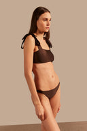 Model wearing the Timeless Straps Bikini Top color coffee made from 85% polyamide 15% elastane, styled for a beachwear look