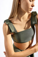 Model wearing the Timeless Straps Bikini Top color croco made from 85% polyamide 15% elastane, styled for a beachwear look