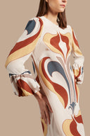 Model wearing the Vintage Lily Long Dress showcasing the close up of it's long sleeves piece, on a silk fabric.