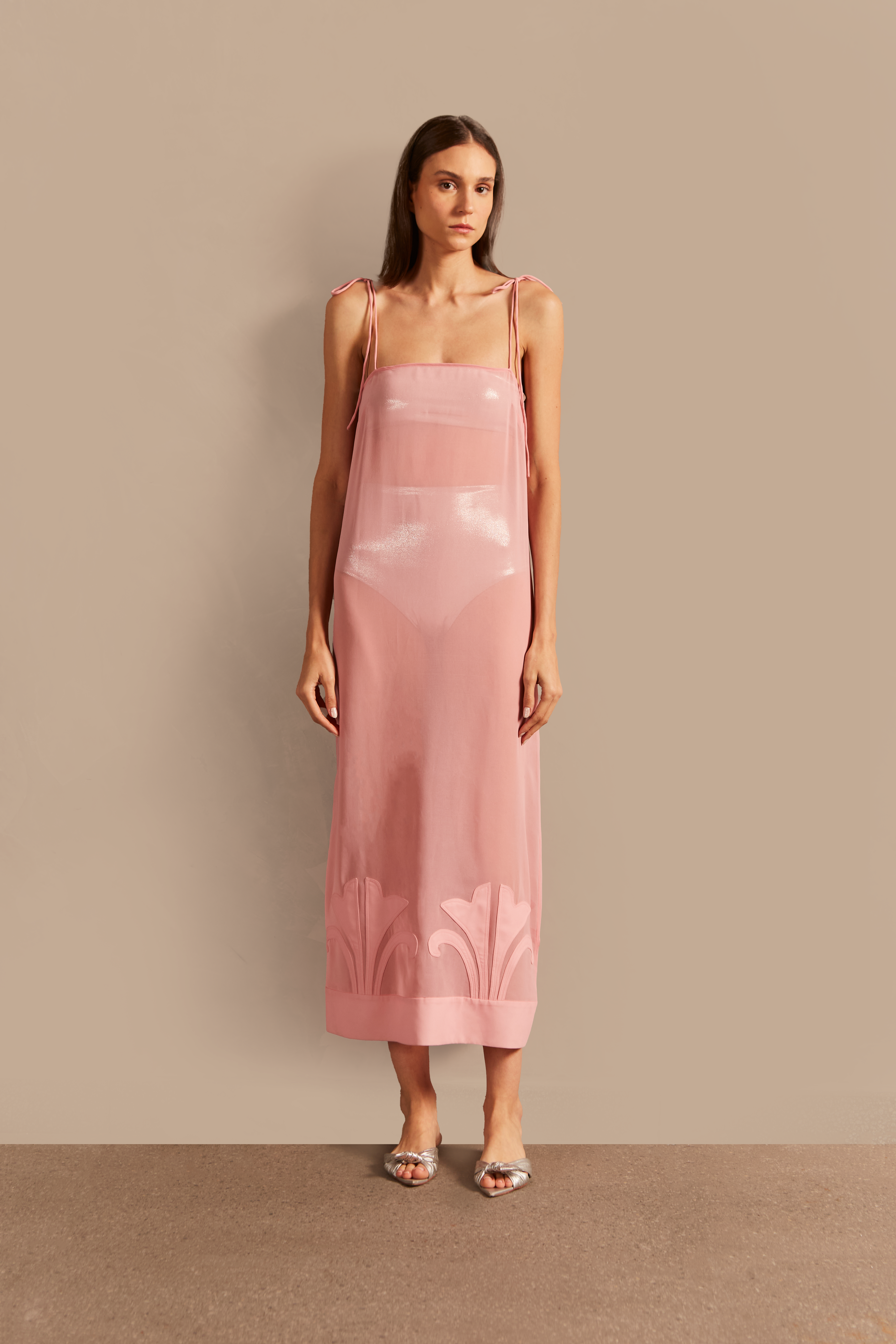 Model wearing the Vintage Lily Midi Dress with Application showcasing the front with Pink color and applications, on a 100% polyester fabric.  