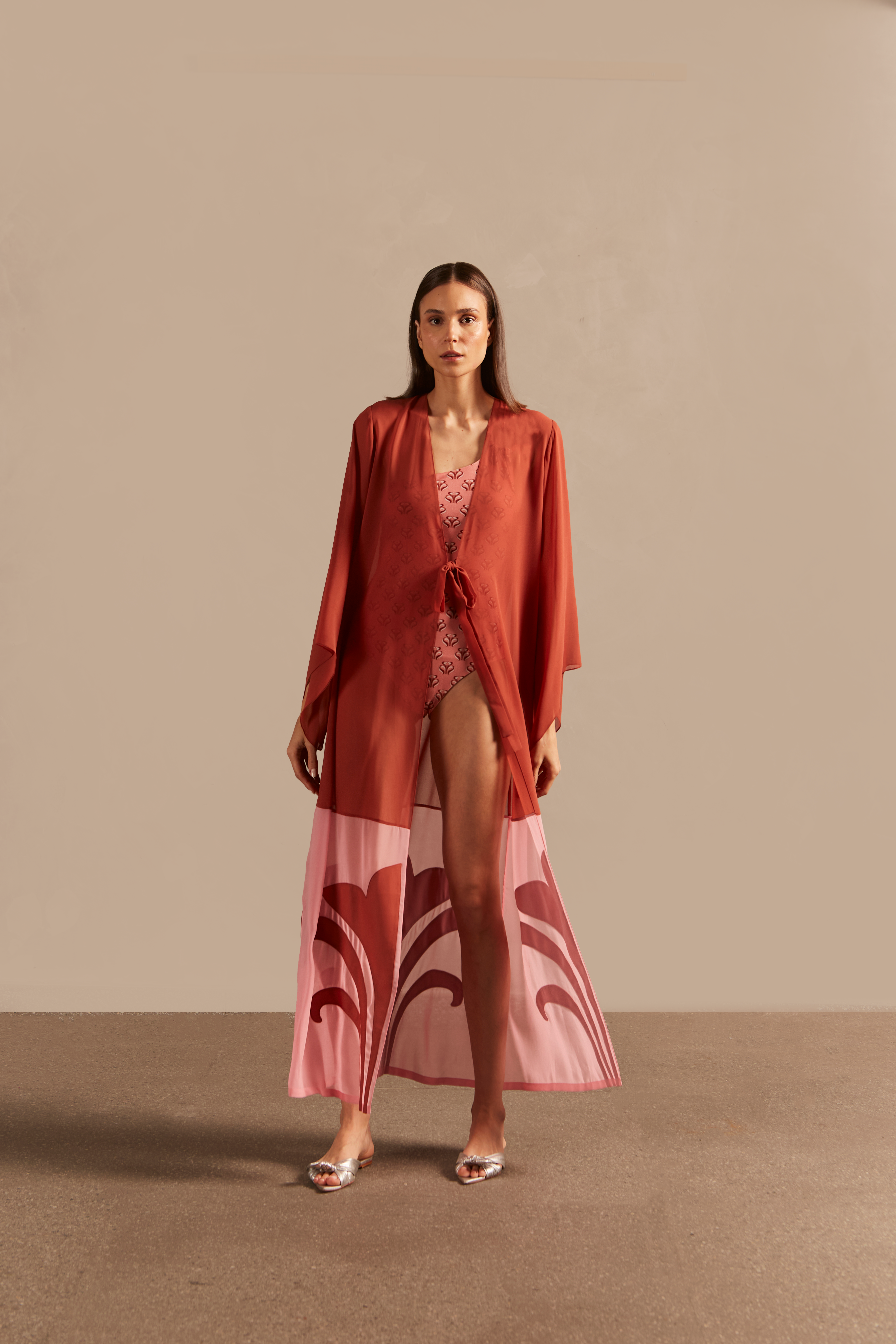 Model wearing the Vintage Lily Solid Appliqué Long Robe showcasing the front of it's vintage inspired dark red and pink print, on a polyester fabric.