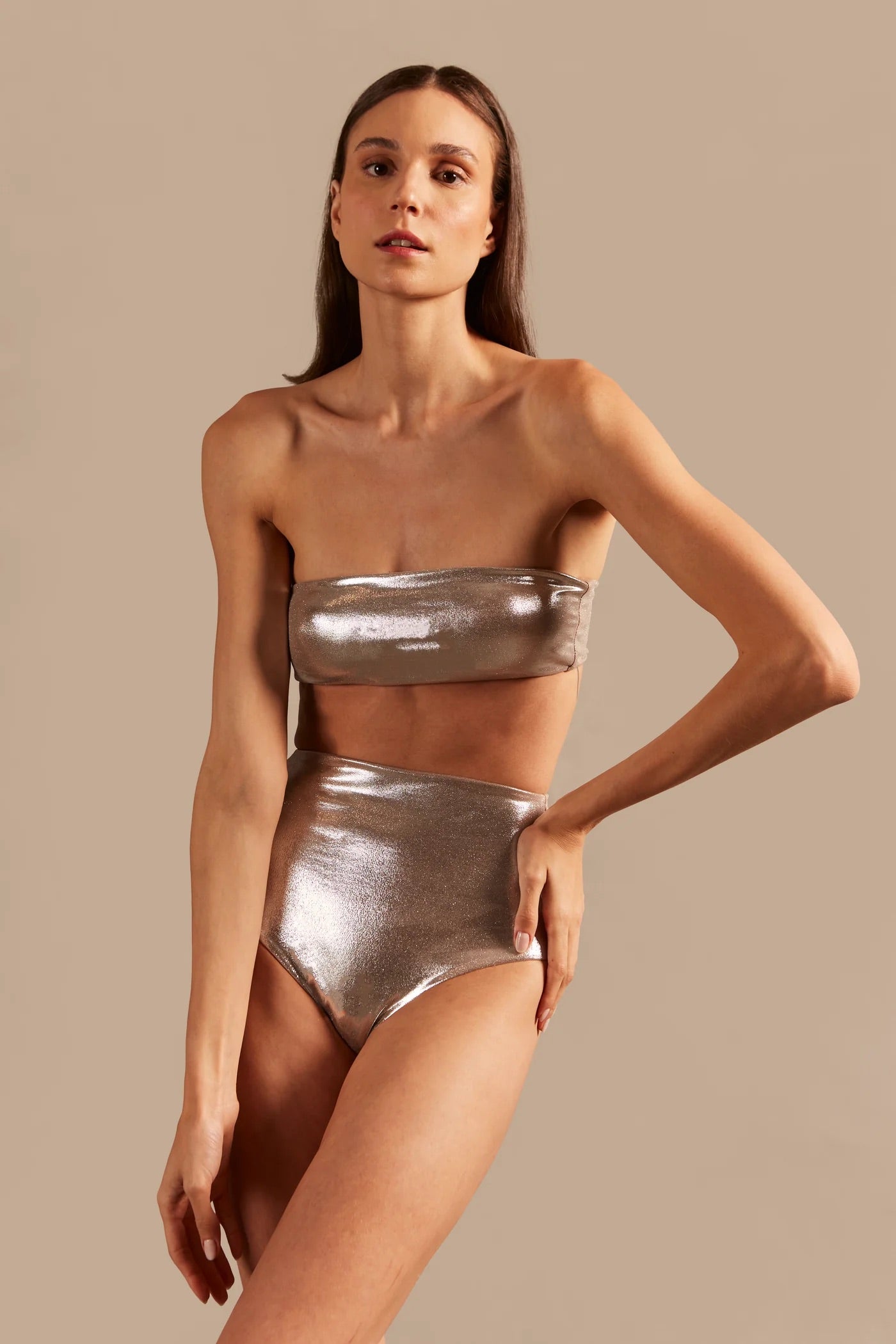 Model wearing the Vintage Lily Solid Silver Lurex High-Waisted Bandeau Bikini showcasing the close up of it's innovative model, on a stretchy fabric.