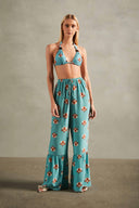 Model wearing the Vintage Orchid Pants presenting its 100% silk fabric, styled for a resort look.