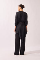 Model wearing the Wide-Leg Jersey Pants color black, made from 100% polysters, styled for a resort look