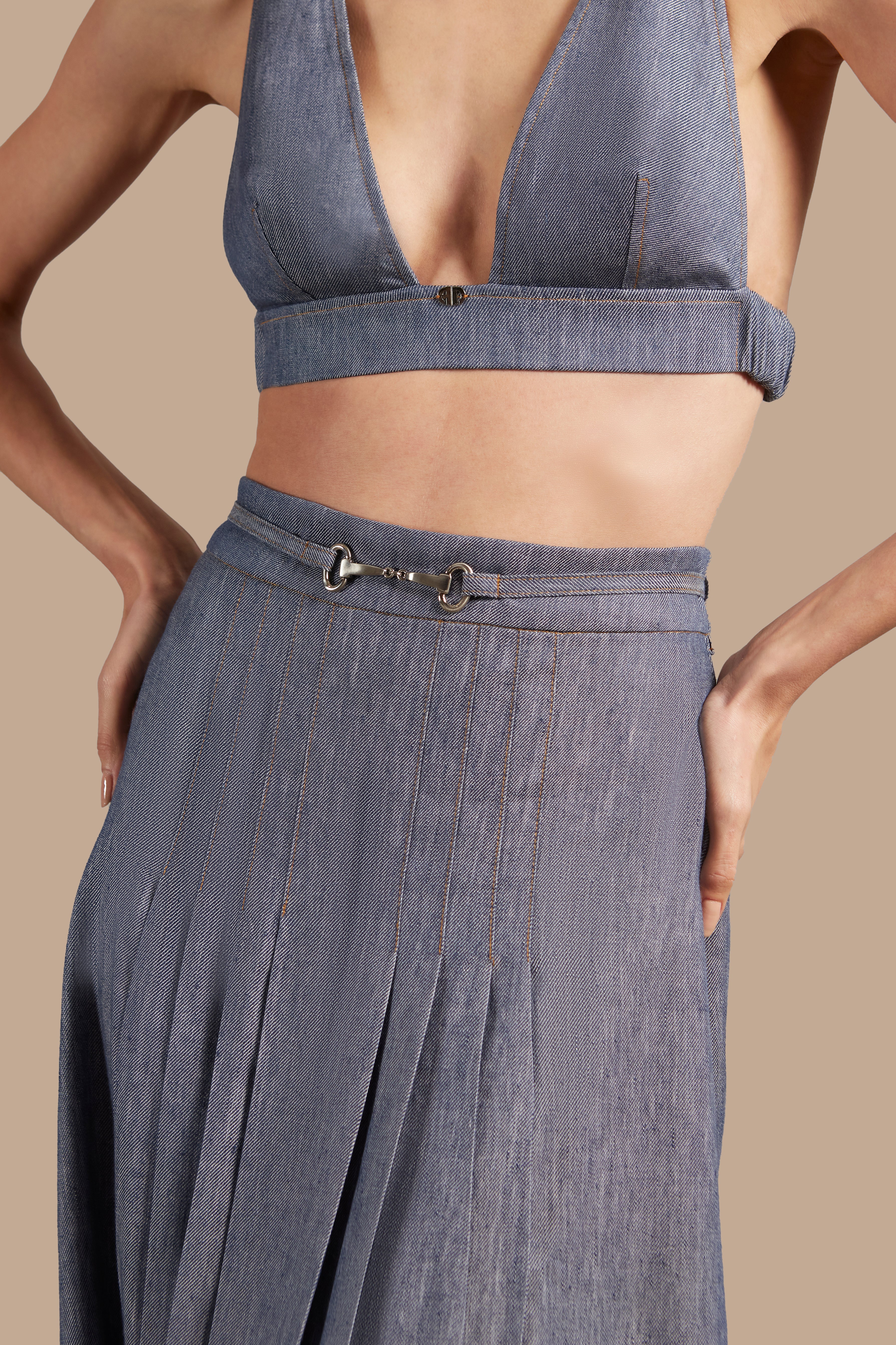 Close-up view of Adriana Degreas' Jeans Pleated Midi Skirt, highlighting the high-waist design and pleated details in a denim-inspired blue fabric.