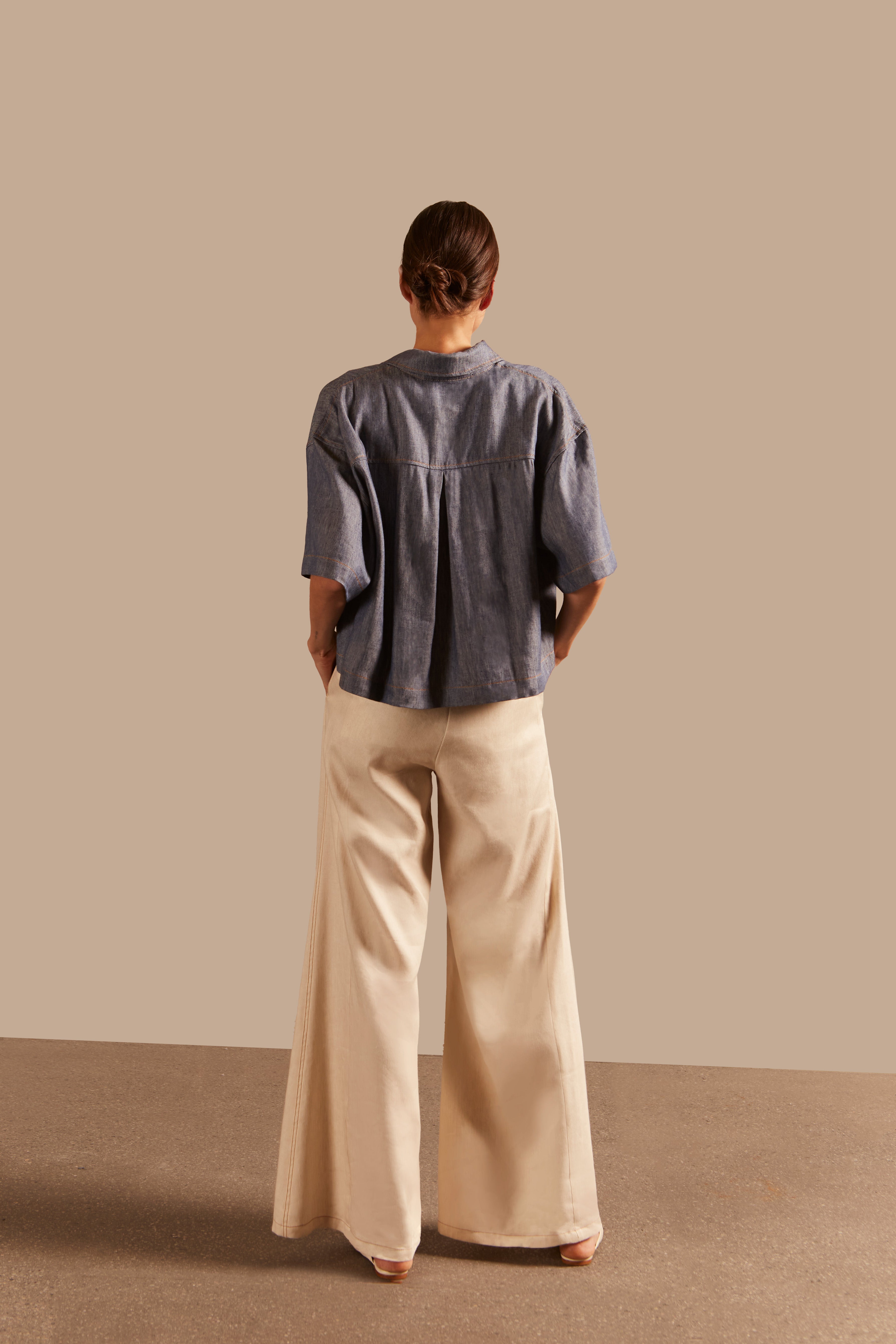 Back view of Adriana Degreas' Jeans Short-Sleeved Shirt in blue, showcasing its relaxed fit and lightweight fabric.