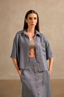 Front view of Adriana Degreas' Jeans Short-Sleeved Shirt in a denim-inspired blue, featuring a loose silhouette, short sleeves, and button-down design.