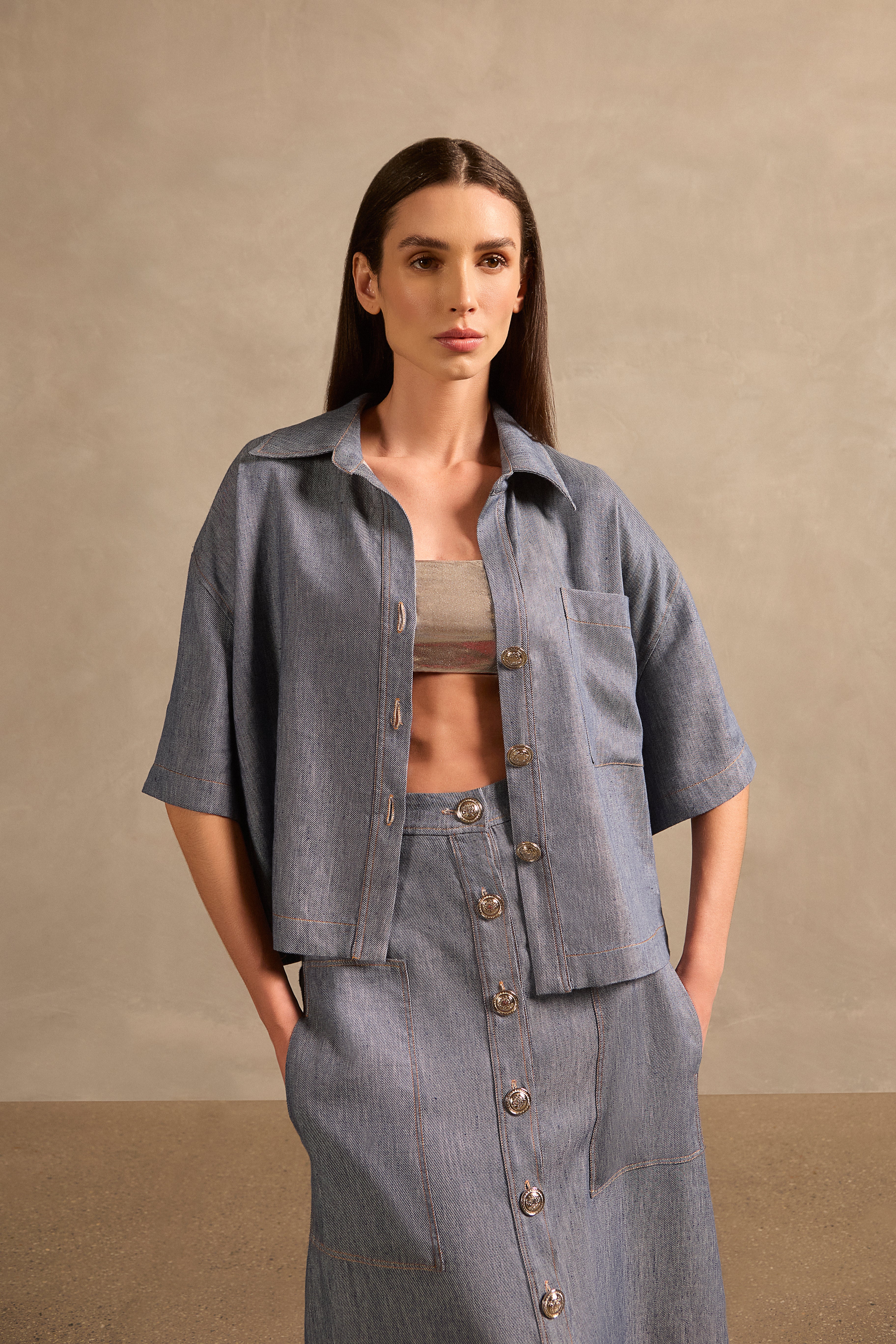 Front view of Adriana Degreas' Jeans Short-Sleeved Shirt in a denim-inspired blue, featuring a loose silhouette, short sleeves, and button-down design.