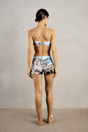 Back view of Adriana Degreas' Postcard Genderless Shorts, showcasing a low-waist design and vibrant postcard print.