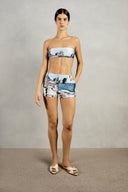 Front view of Adriana Degreas' Postcard Genderless Shorts in a vibrant blue postcard print, featuring a low-waist fit and practical pockets.
