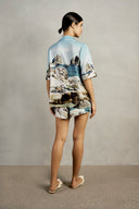 Back view of Adriana Degreas' Postcard Shorts in blue postcard print, showcasing the loose fit and lightweight viscose fabric.