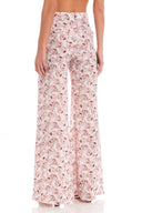 Model wearing the Aglio Wide Leg Pants showcasing the back of it's high-waited piece, with Aglio Print, on a silk fabric.