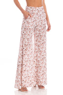 Model wearing the Aglio Wide Leg Pants showcasing the front of it's high-waited piece, with Aglio Print, on a silk fabric.