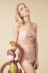 The high waisted hot pants paired with a structured kiss-shaped top is a modern interpretation of classic 1950’s shapes